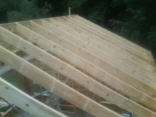 New roof rafters set over an addition before sheathing in Columbus